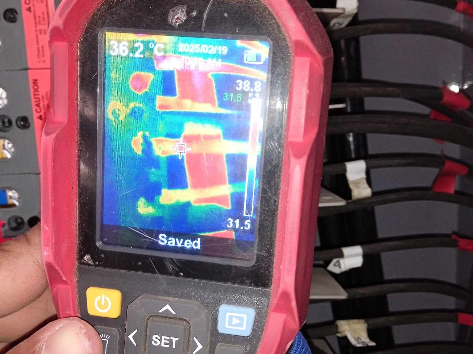 A Magnus technician thermal-scanning a live combiner during a maintenance visit