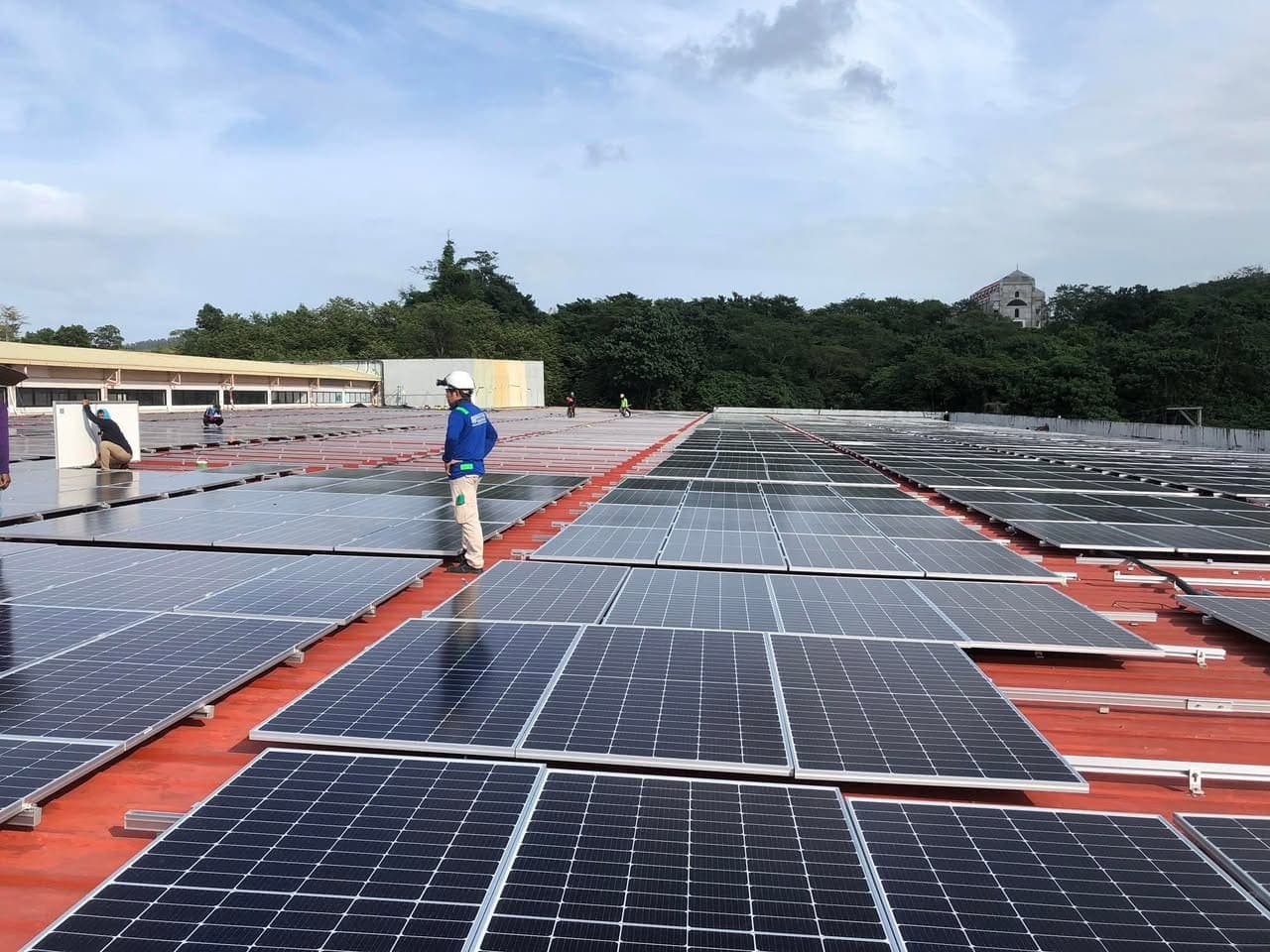 A completed commercial rooftop solar array under an open sky
